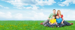 Happy family relaxing in park.